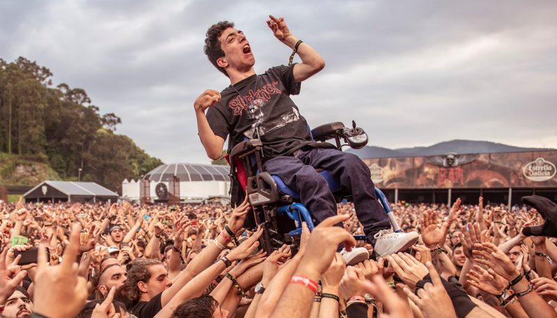 WATCH: Glorious moment metal fans help young buck in wheelchair crowd surf goes viral