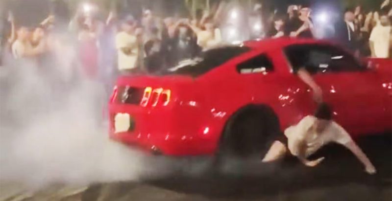 WATCH: Guy gets pantsed by a Mustang doing a burnout in hectic video
