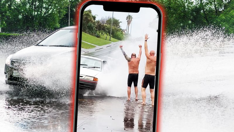 WATCH: Kiwi blokes go viral for getting drivers to splash 'em on flooded NZ street